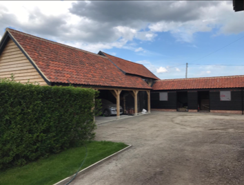 garage roof repair using red tiles in Norwich