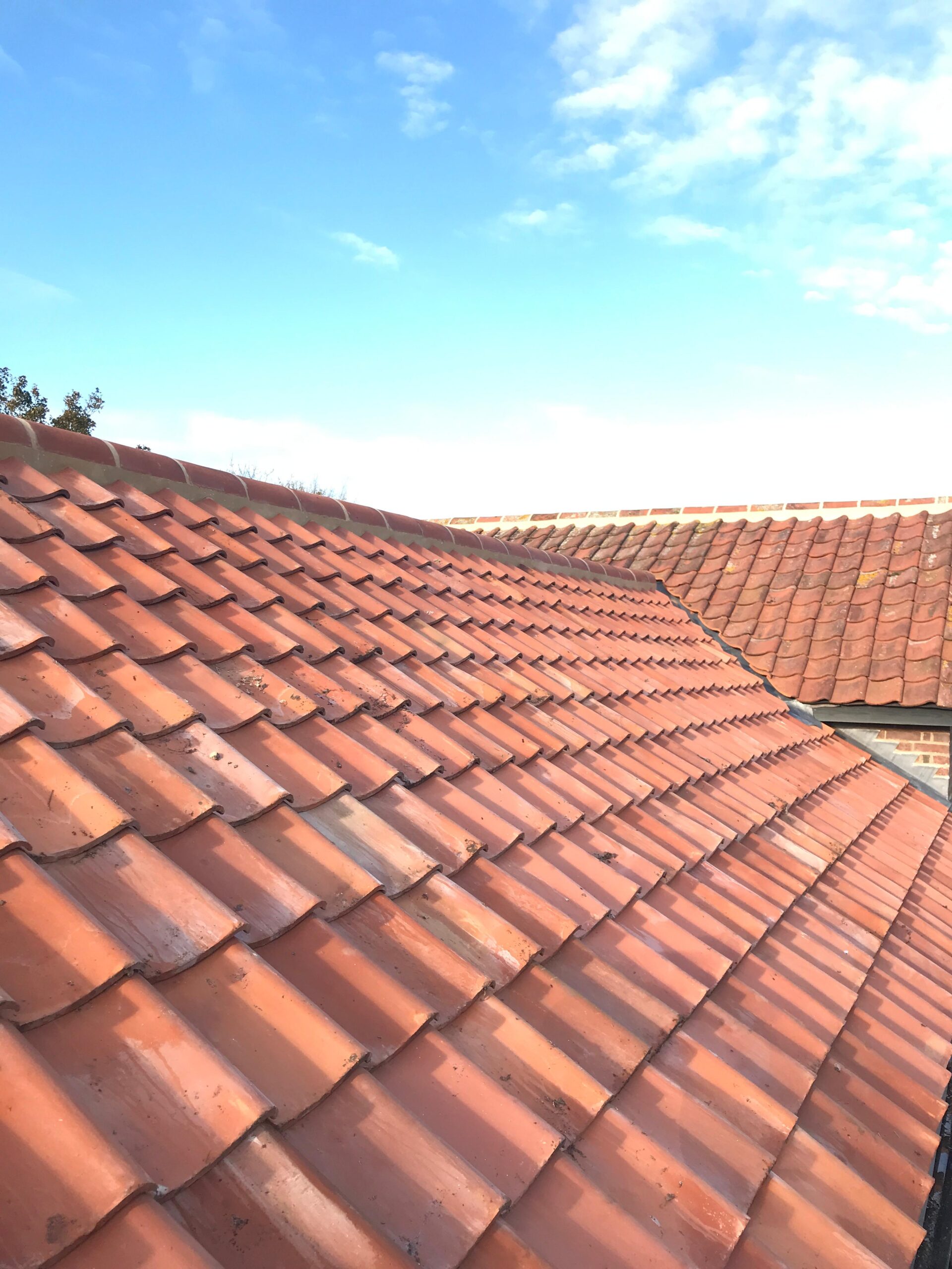 Close view along a newly tiled red pantile roof