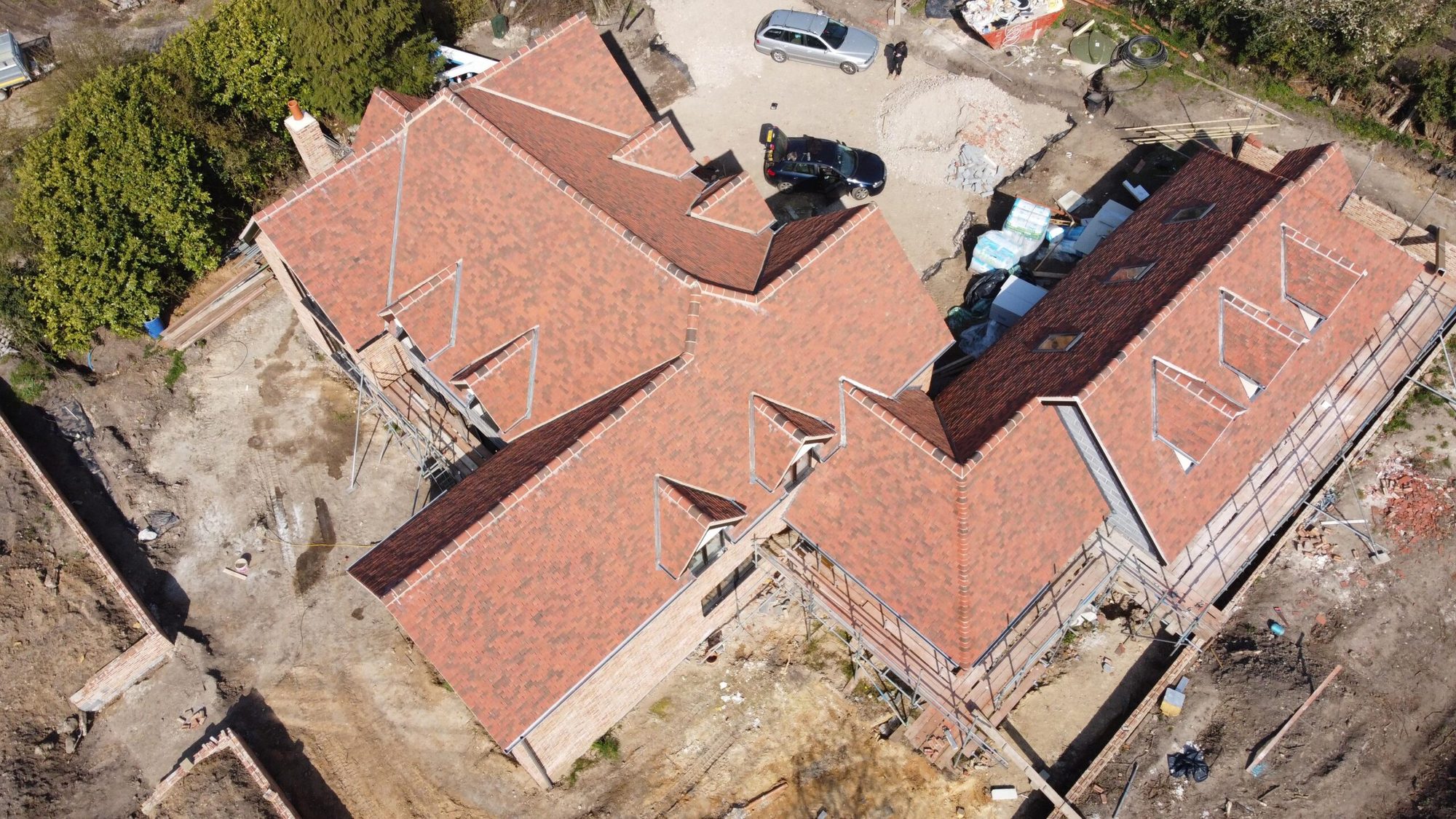 Aerial view of a red tiled roof on a house under construction