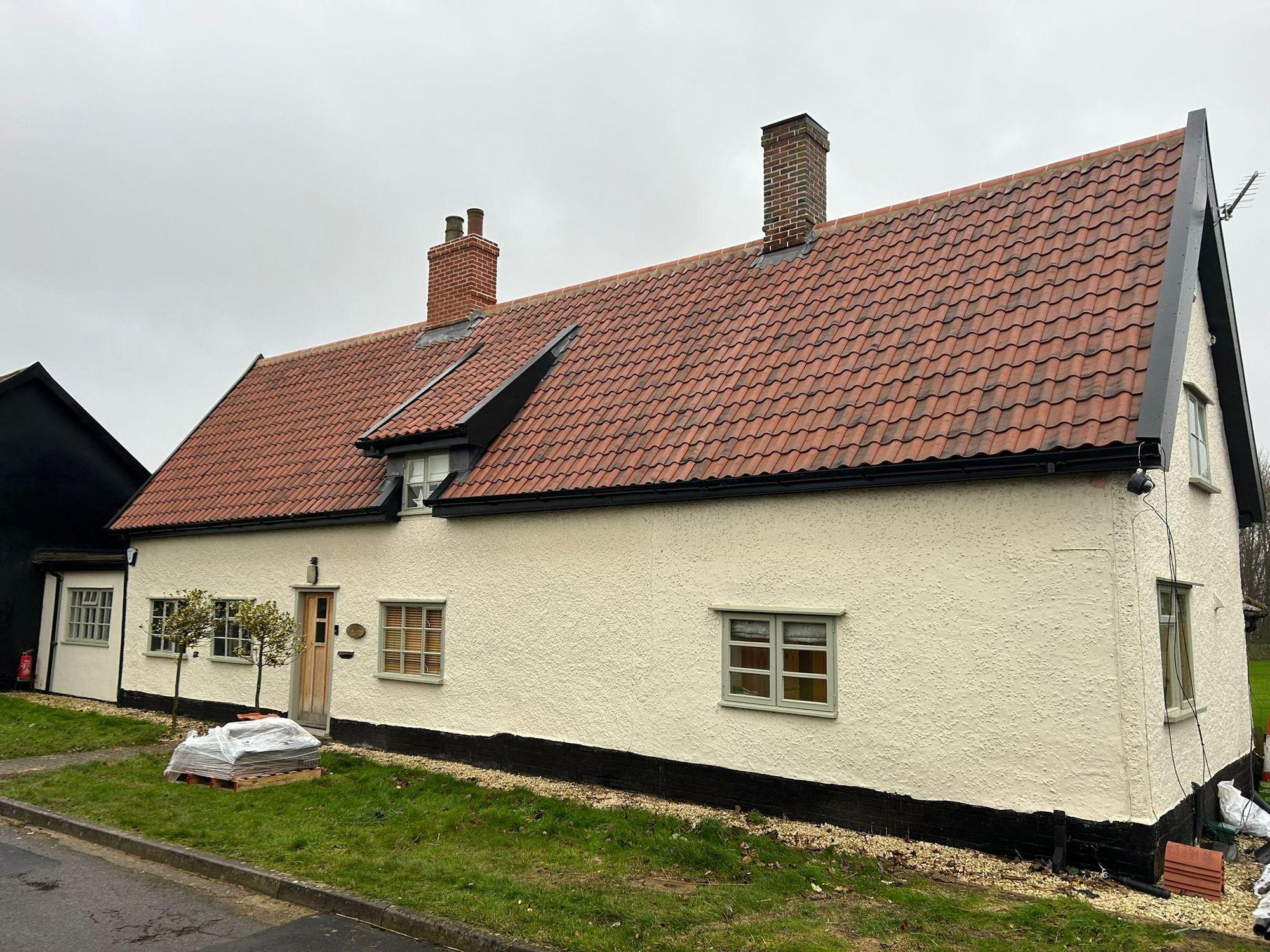Cottage with a new red pantile roof and chimney