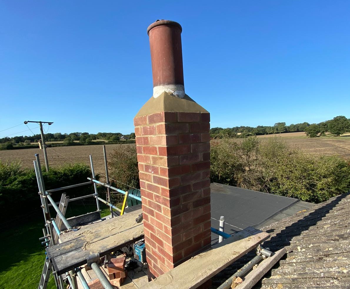 Brick chimney stack with lead flashing at the roof line